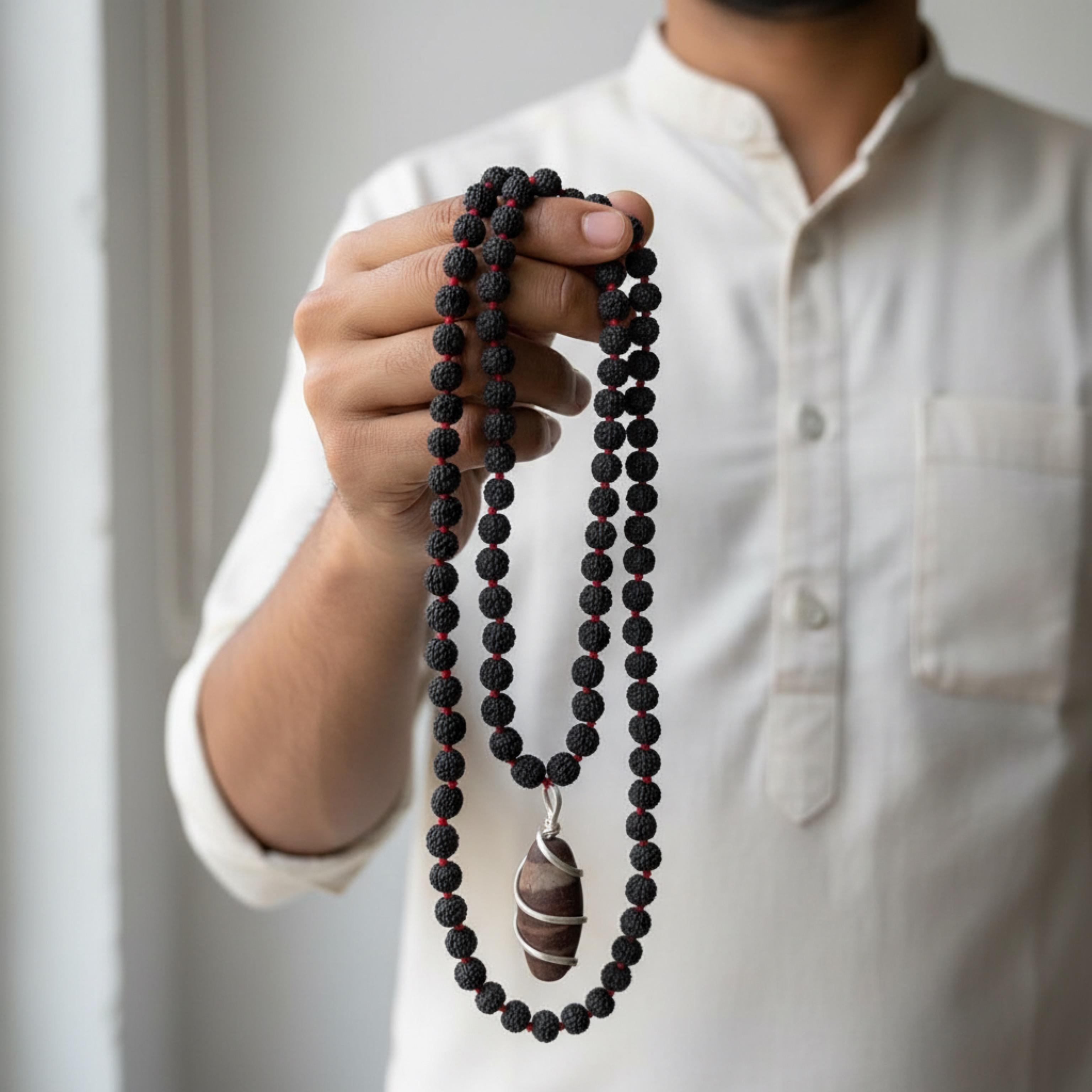 Kashivardan Black Rudraksha Mala with Silver Wire Wrapped Narmadeshwar Stone Pendant | 8mm Natural Beads | Blessed and Purified with Gangajal | Idol for Mens & Womens | Meditation & Pooja